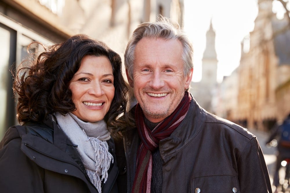 Couple smiling together on a walk.