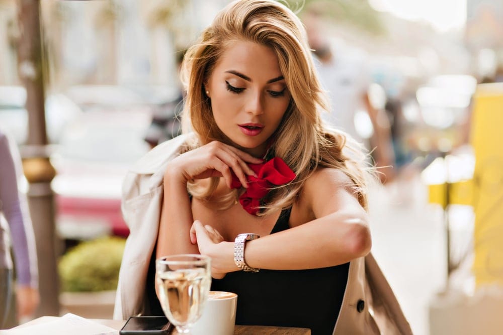 Woman looking at the time on her watch.