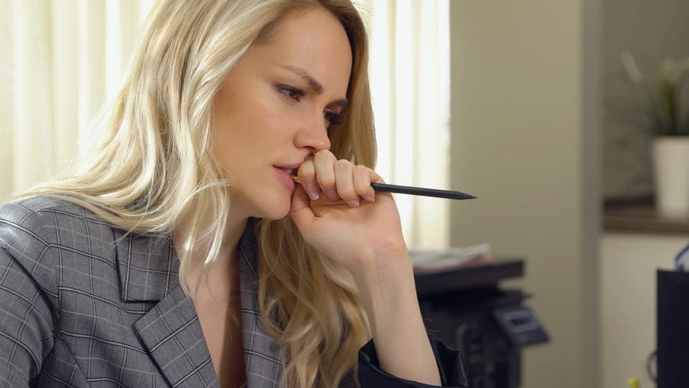 Woman holding a pen.
