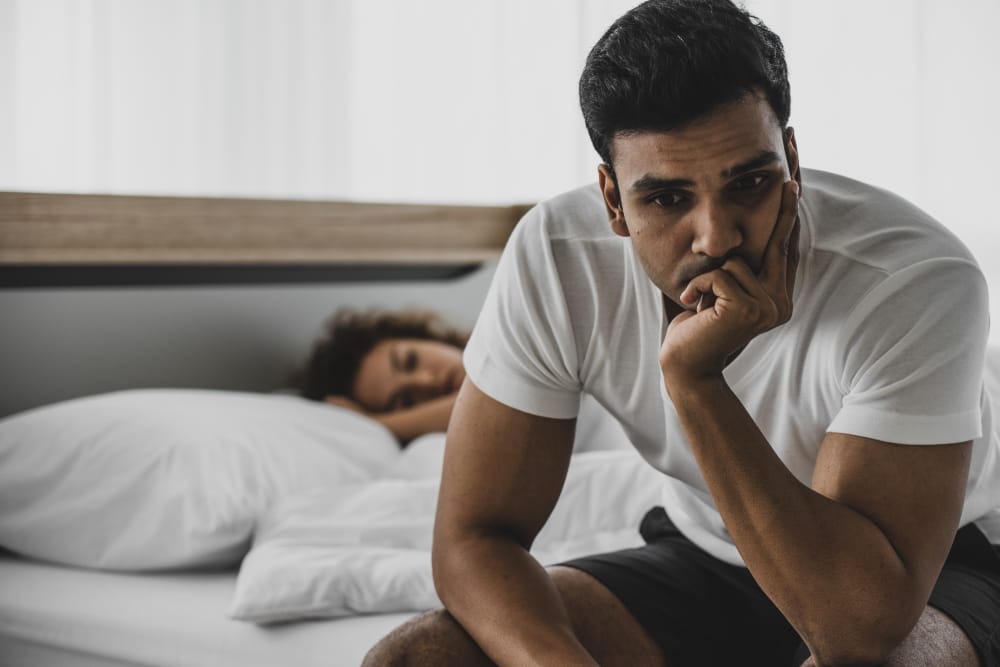 Couple in an argument in bed.