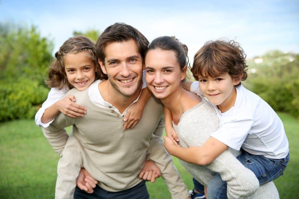 Parents giving piggyback rides.