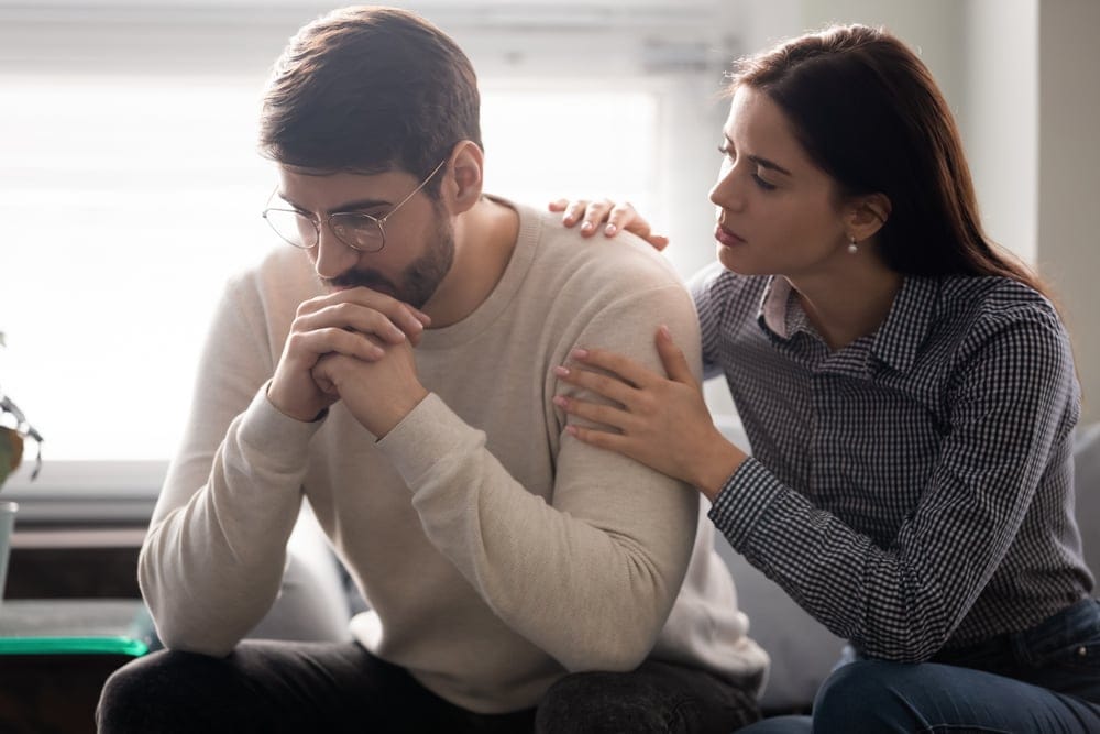 Woman tried to comfort her husband.