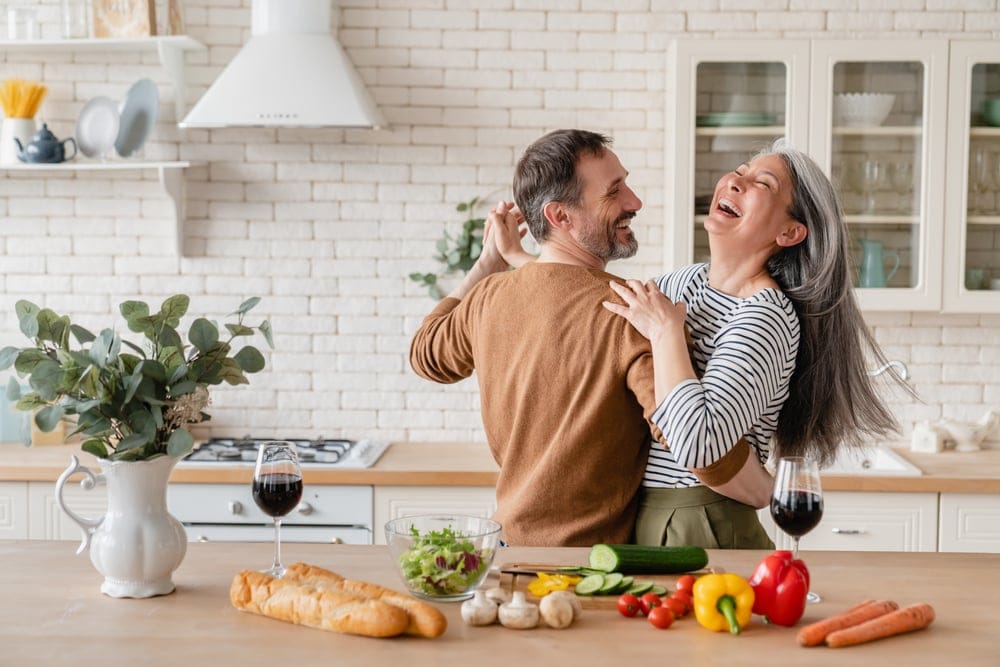 Happy couple cooking dinner together.