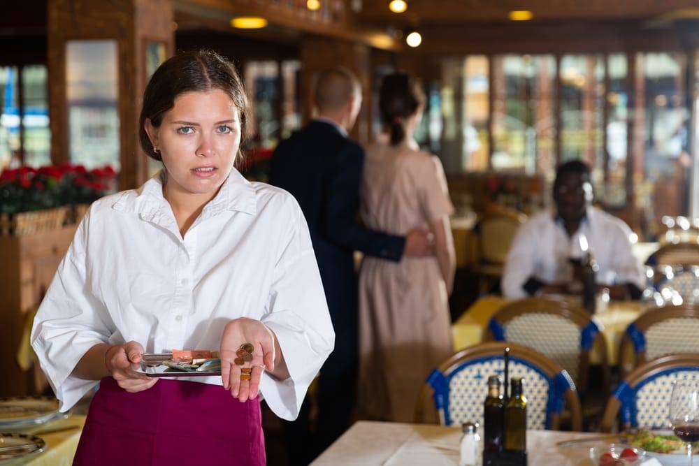 Upset waitress receiving a bad tip.