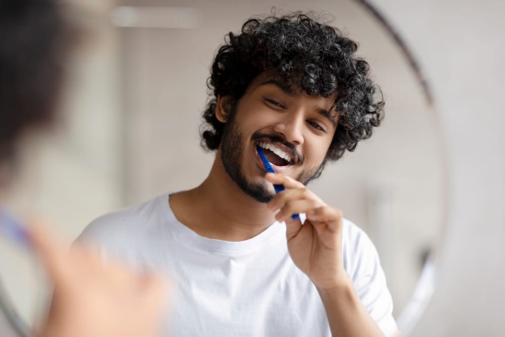 Man brushing his teeth.