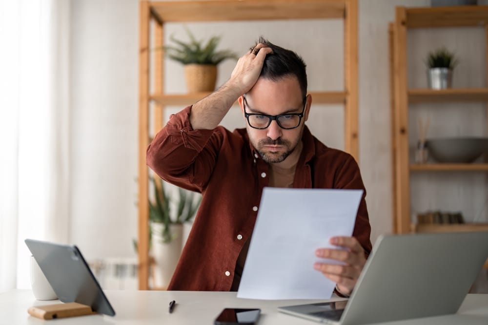 stressed man working out finances