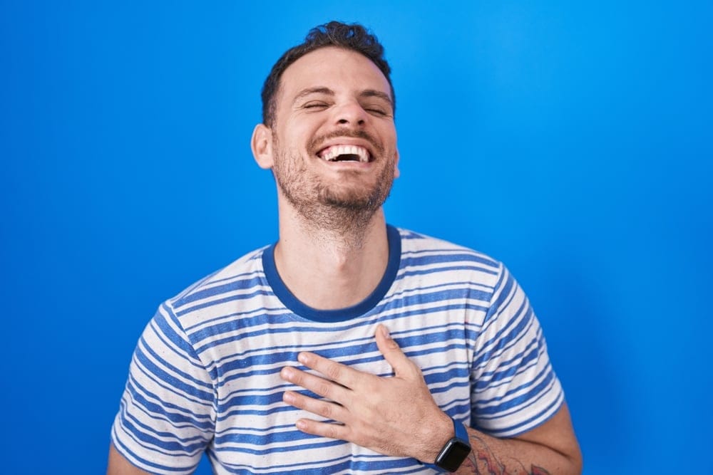Man laughing heartily.