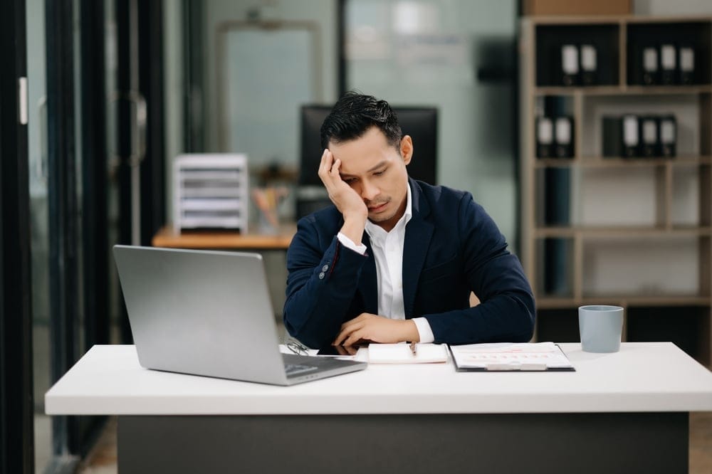 Overworked man at his desk.