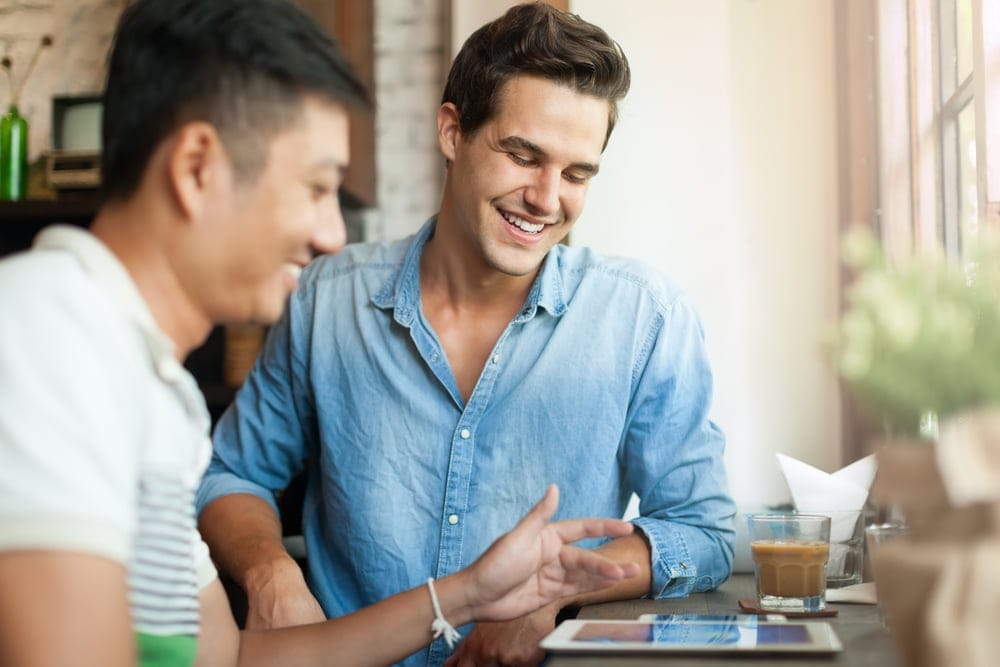 Two men laughing together.