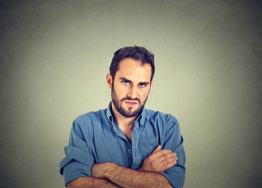 Angry man with crossed arms.