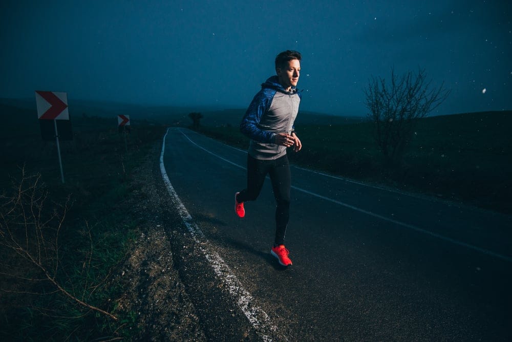 Man running outside at night.