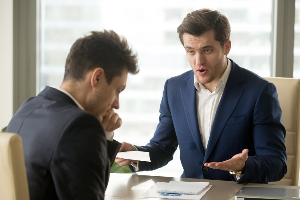 Angry boss with his coworker in the office.