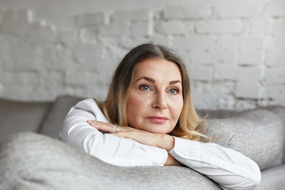 An attractive middle aged woman lost in thought