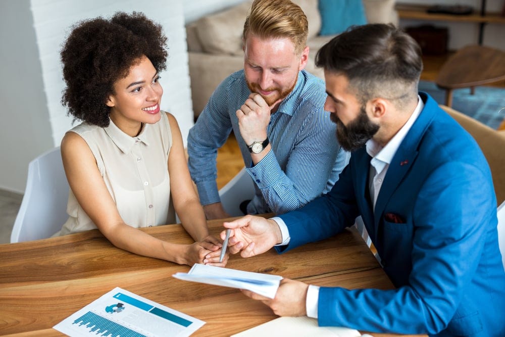 Couple discussing a mortgage, loan, paperwork, legal or insurance with a professional