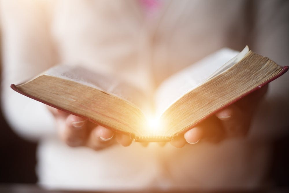 Woman holding a book.