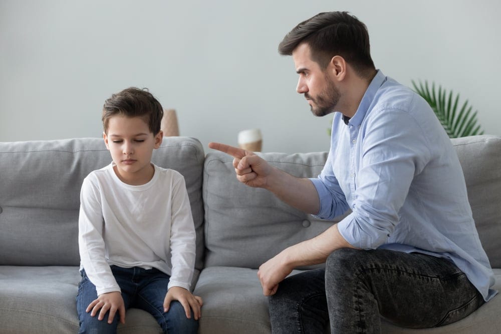 Father scolding his son.