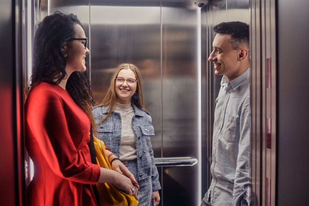 People riding in an elevator.