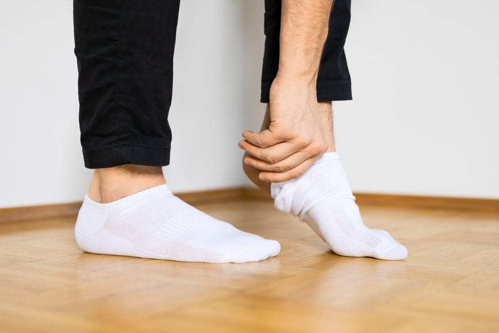 Man putting his socks on.