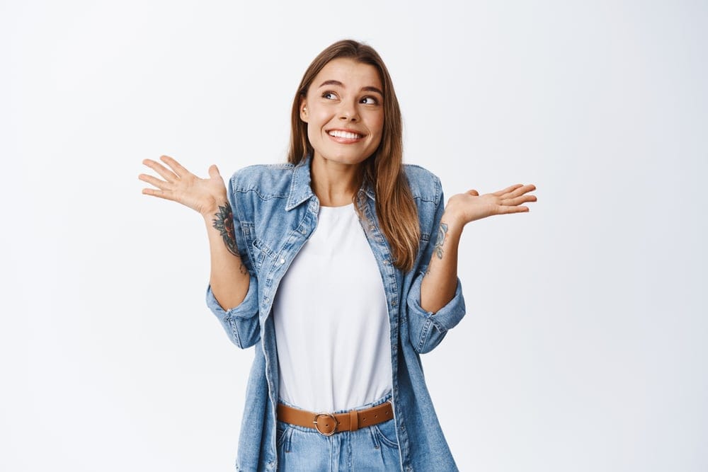 Woman acting innocent with a shrug.