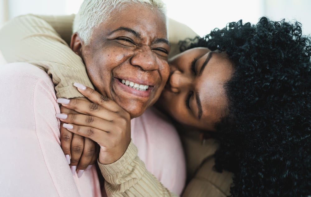 Mother and daughter embracing.