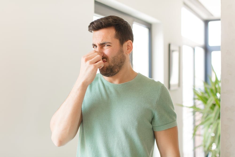 Man holding his nose.