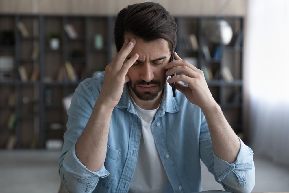 Unhappy man on the phone.