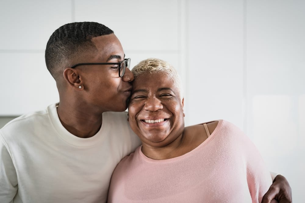 Mother and son hugging one another.