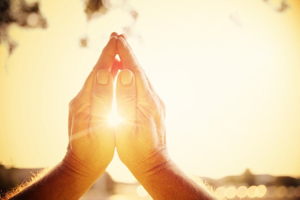 Praying hands clasped together.