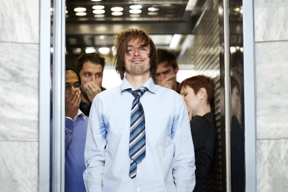 Man in elevator needs a shower.