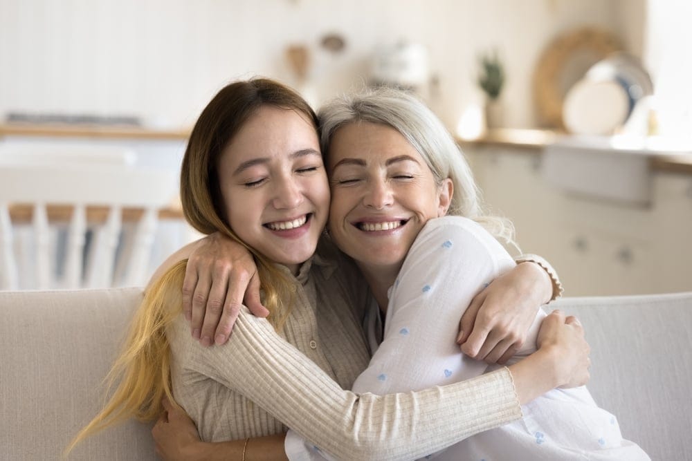 Two women hugging.