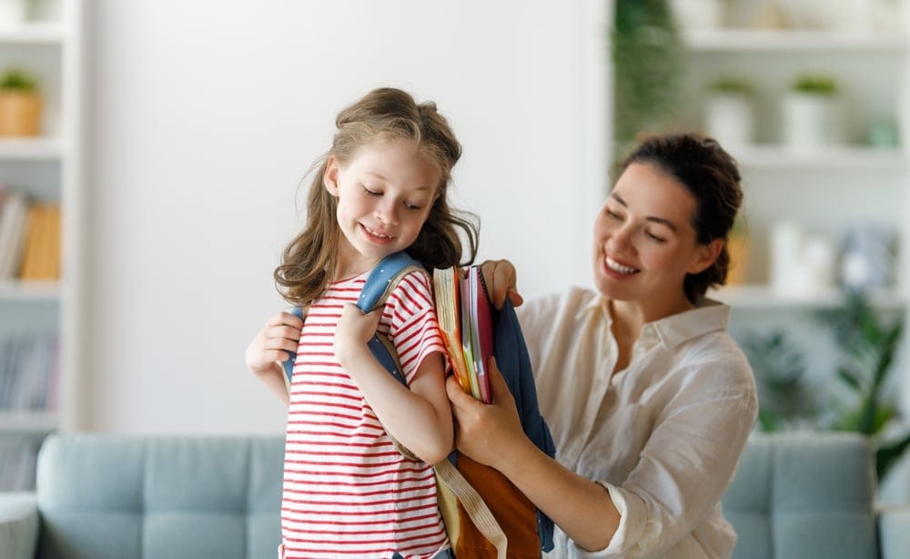 Mom getting her daughter off to school.
