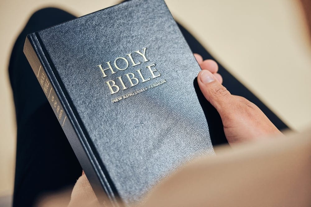 Hands holding a bible.