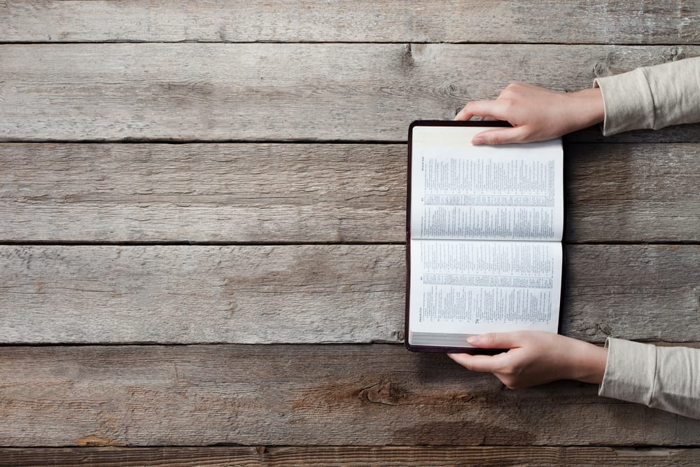 Woman's hands on a bible.