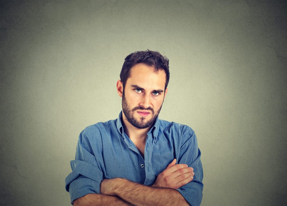 Unhappy man with arms crossed.