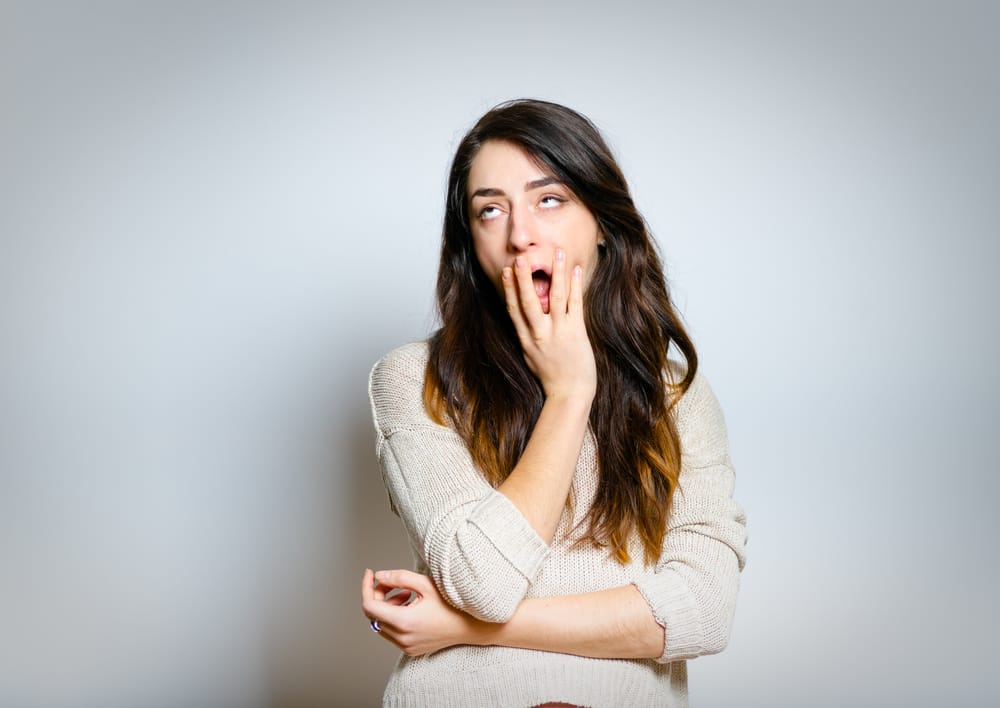 Woman yawning with boredom.