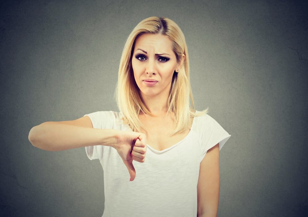 Woman giving a thumbs down.