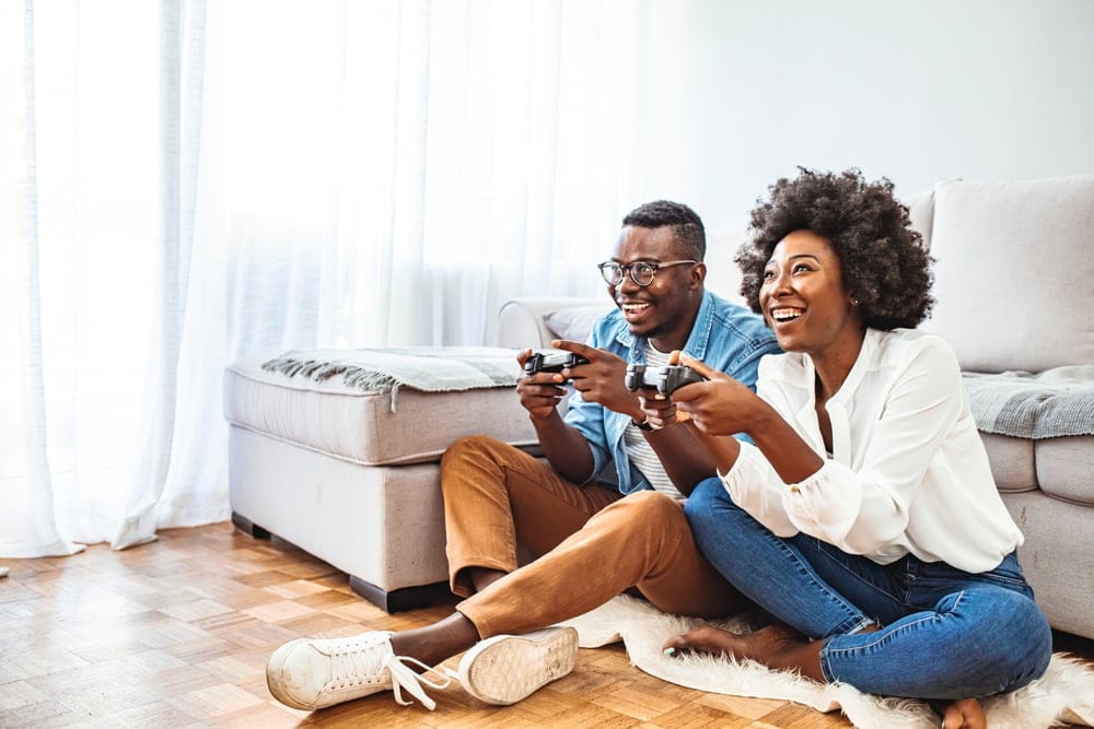 young couple playing video games at home