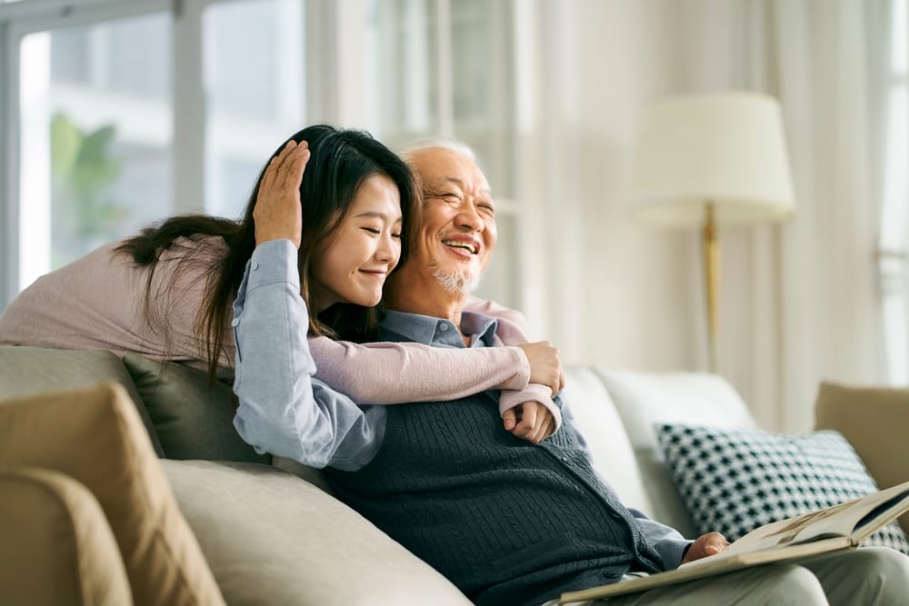 A father and daughter embracing at home.