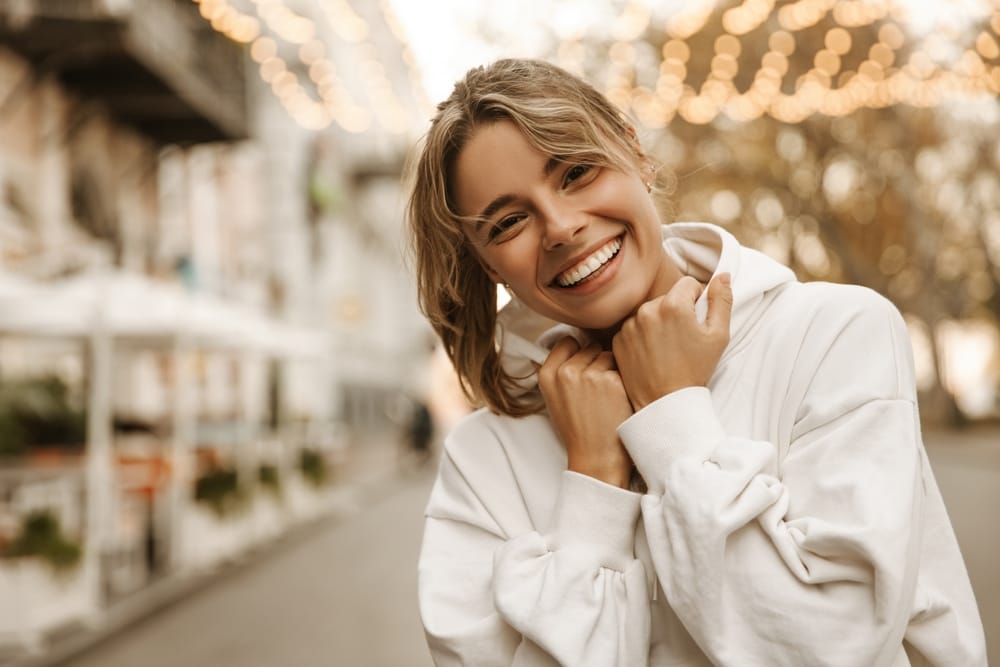 Woman smiling and looking welcoming.