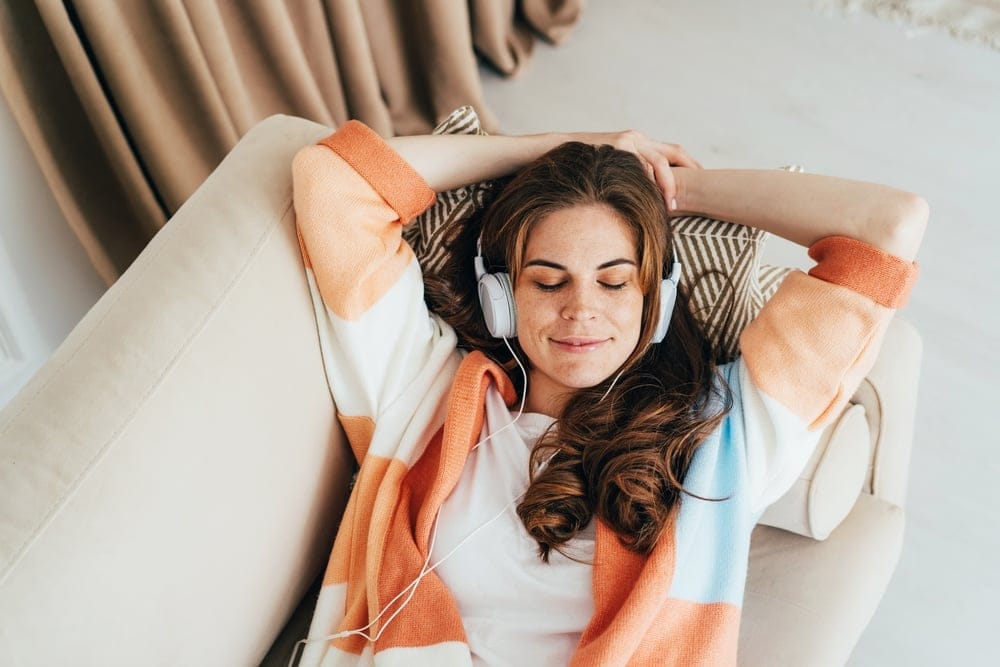 Woman meditating and listening to music with her headphones alone.