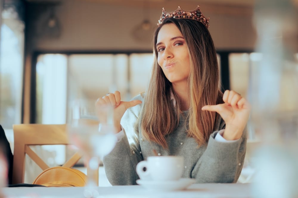 An arrogant, entitled woman with a cup of coffee