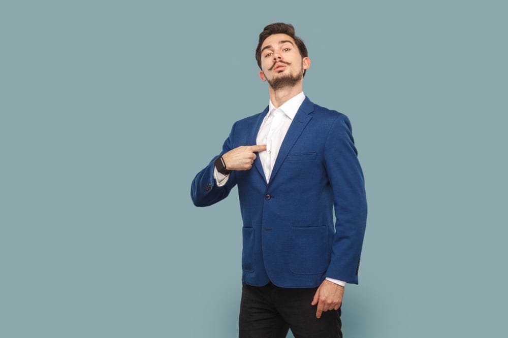 Confident man pointing to himself.