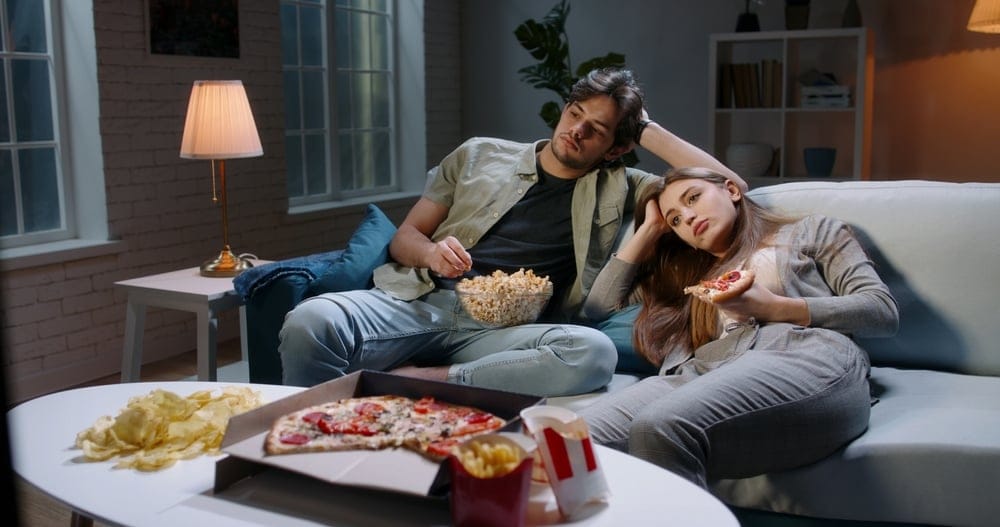 Couple watching TV together.