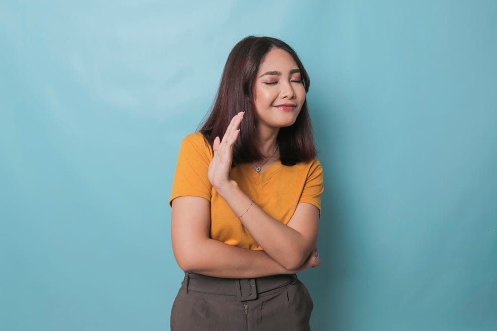 Woman saying no with her hand gesture.