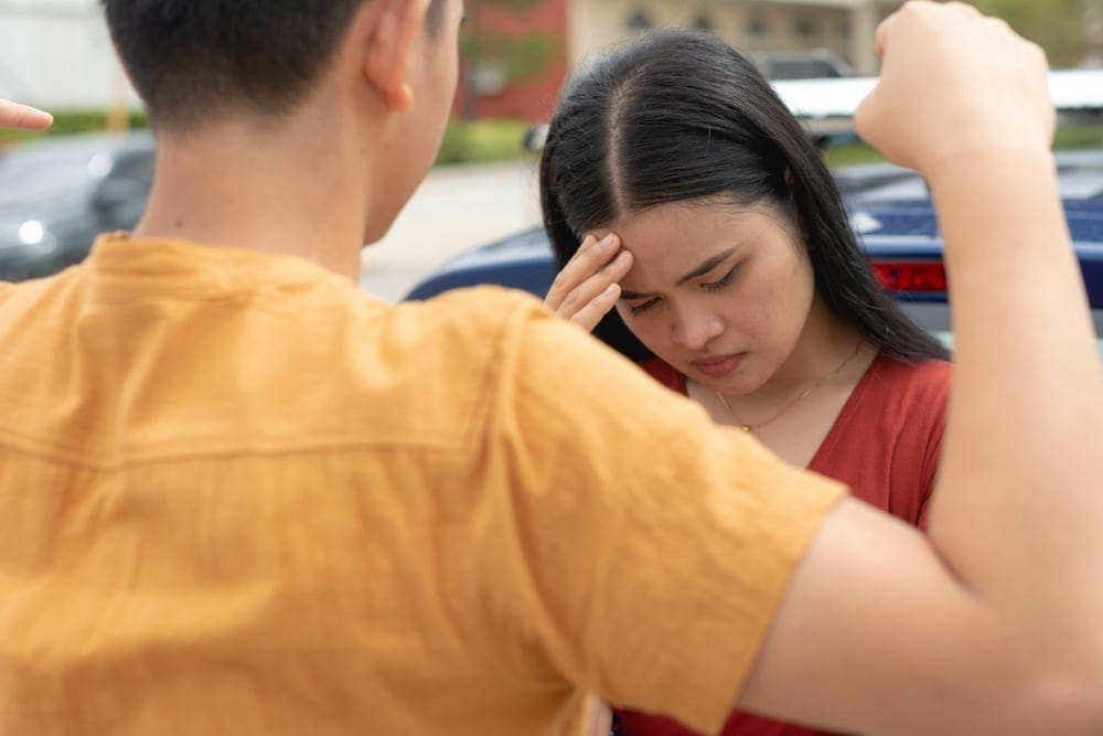 A woman hanging her head in shame after being publicly berated