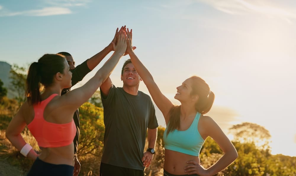 Group of friends giving high five.