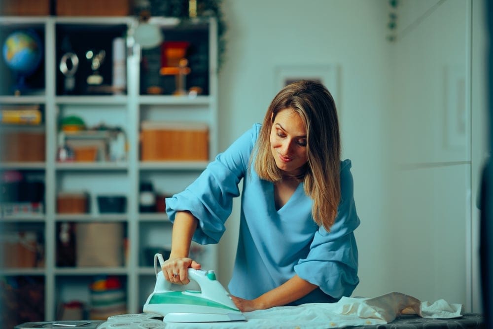 Woman ironing at home.