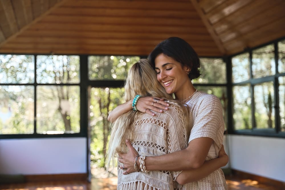 Two women embracing.