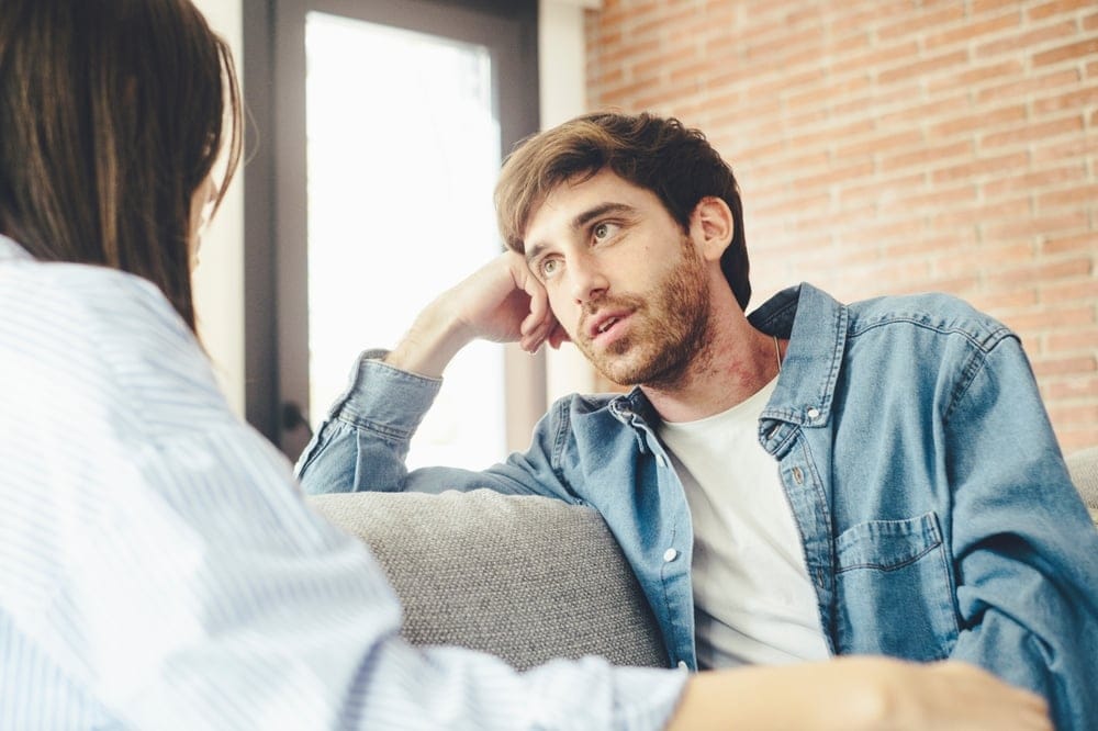 Stressed young couple working through an argument.