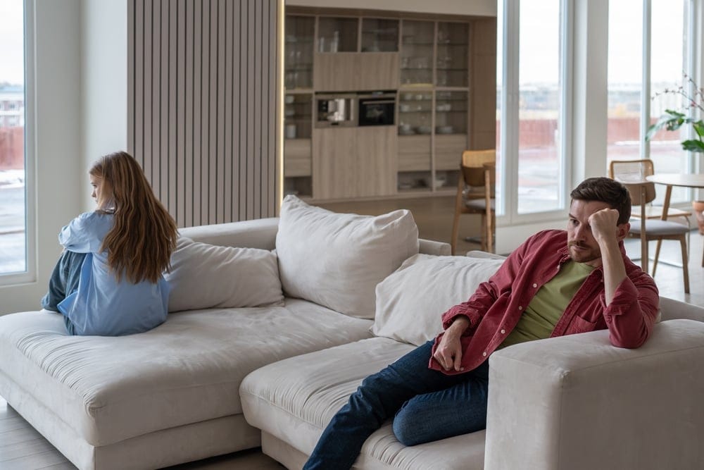 Man and woman fighting on the couch.